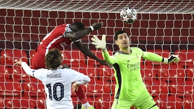 Liverpool's Sadio Mane and Real goalkeeper Thibaut Courtois challenge for the ball. EPA