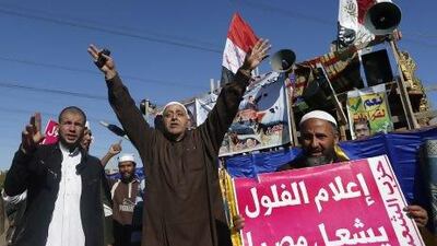 Islamist protesters supporting Egyptian president Mohammed Morsi outside the Media City complex in Giza. Their sign reads "journalist remnants will destroy Egypt”.