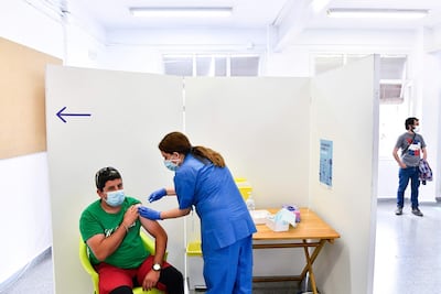 An agricultural worker receives a jab of the J&J/Janssen Covid-19 vaccine at a vaccination centre in Alcarras, near Lleida, Spain. AFP
