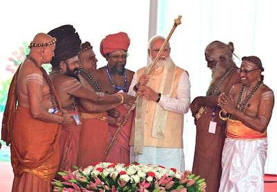 Hindu priests hand over a golden sceptre to Prime Minister Narendra Modi to be installed India's new parliament building. AP Photo
