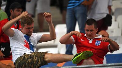 A Russia supporter, left, clashes with an England supporter in the stands during the UEFA EURO 2016 group B preliminary round match between England and Russia at Stade Velodrome in Marseille, France. Peter Powell / EPA