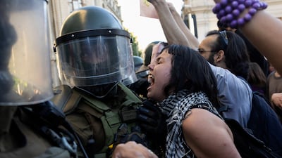 Protesters clash with riot police during a demonstration to demand the resignation of Chile's Minister of Justice Fernando Rabat, after disputed sentence reductions granted to prisoners convicted of sexually abusing minors, in Santiago. Reuters