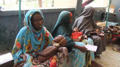 July 25 2011: Mothers from southern Somalia hold their malnourished children at Banadir hospital in Mogadishu. Farah Abdi Warsameh / AP Photo