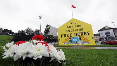 A floral tribute in memory of John Hume is pictured at the Free Derry Corner in Derry. Reuters