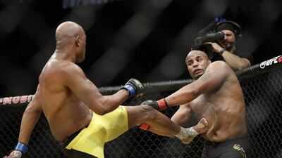 Anderson Silva kicks Daniel Cormier during their light heavyweight bout at UFC 200, Saturday, July 9, 2016, in Las Vegas. John Locher / AP Photo