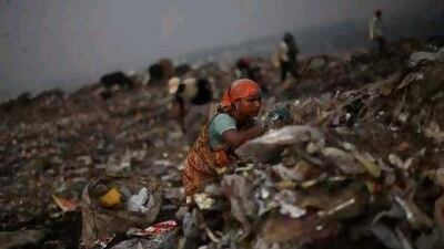 An Indian ragpicker searches for reusable garbage at a dumping ground on the outskirts of New Delhi. Those whose survival depends on trash fear their lives are about to be upended.