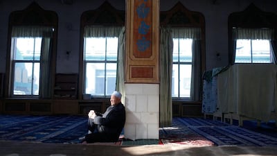 A Hui Muslim man basks in a ray of sunlight. Sarah Dea / The National