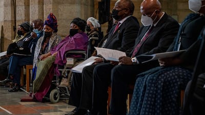 Tutu's widow, Leah, wearing purple, sits across the aisle from King Letsie III of Lesotho and South African President Cyril Ramaphosa, second from right. AFP