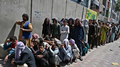 People queue outside a bank to withdraw money in the Shar-e-Naw district of Kabul. AFP