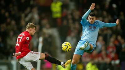 Manchester United full-back Brandon Williams attempts a clearance as Burnley's Jack Cork tries to block the ball. EPA