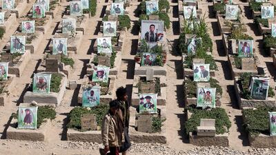 Pro-Houthi Yemenis walk past portraits on the graves of Houthi militia members allegedly killed in ongoing fighting, during the funeral of Houthi militiamen, at a cemetery in Sana'a, Yemen. EPA