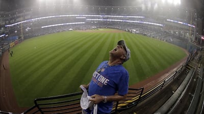A Chicago Cubs fan catches rain drops in his month after the Game 7 victory. Charlie Riedel / AP