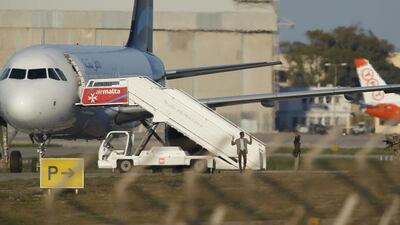 Two hijackers of a Libyan Afriqiyah Airways Airbus A320 surrender on December 23, 2016 to Maltese military on the runway at Malta airport. Darrin Zammit-Lupi / Reuters