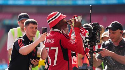 Manchester United's Kobbie Mainoo celebrates with the FA Cup Trophy. PA