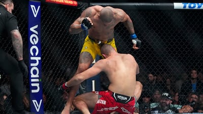 Alex Pereira punches Jiri Prochazka during the second round of their light heavyweight title bout at UFC 295. AP
