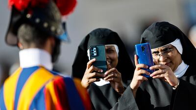 Nuns take pictures of a Swiss Guard as they gather for the Holy Mass for the Jubilee of Consecrated Life in St Peter's Square, Vatican City. EPA