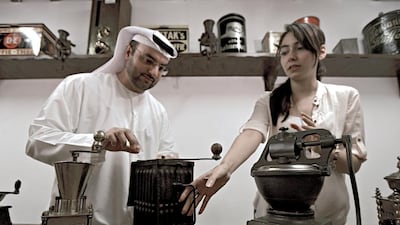 Khalid Al Mulla, the founder of the Coffee Museum, shows two German-made coffee grinders from the Second World War to Arezou Schulz, a project manager at the museum. Ravindranath K / The National