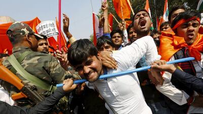 Activists from the Akhil Bharatiya Vidyarthi Parishad (ABVP), the student wing of India’s ruling Bharatiya Janata Party (BJP), scuffle with security personnel during a protest march in New Delhi. Adnan Abidi / Reuters