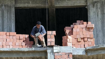 A housing development proposal by Arabtec and Egypt’s government has not moved beyond the planning stages. Above, a builder lays bricks in Cairo. Dana Smillie for The National