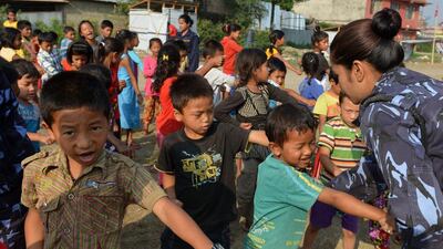 Nepalese police officers conduct a self defence training session for women and childeren at a shelter for earthquake victims in Kathmandu on June 5. AFP Photo