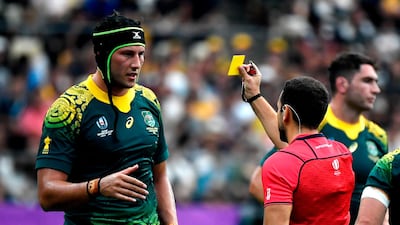 Match referee Mathieu Raynal, right, shows a yellow card to Australia's lock Adam Coleman. AFP