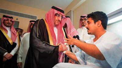 Prince Mohammed bin Nayef, crown prince of Saudi Arabia, visits an injured security officer in hospital in Jeddah. SPA / AP