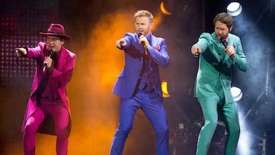 Mark Owen, Gary Barlow and Howard Donald of boy band Take That perform on stage in Hamburg, Germany in 2015.