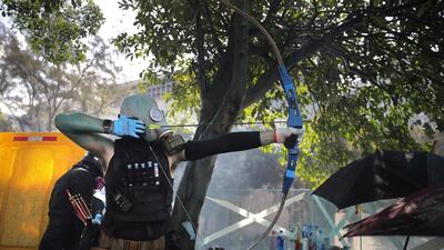 A protester armed with a bow prepares to fire an arrow during a confrontation with police at the Hong Kong Polytechnic University in Hong Kong. AP