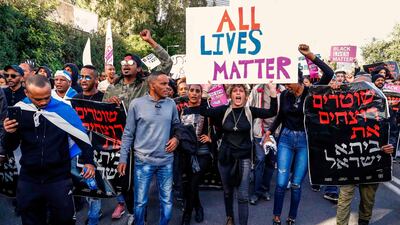 Israelis of Ethiopian origin chant slogans and carry signs as they block a highway in the Israeli city of Tel Aviv on January 30, 2019, during a protest against police violence. AFP