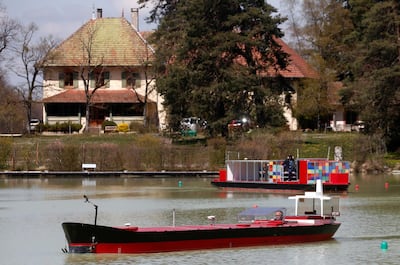 Francois Mayor, managing director of Port Revel, steers a scaled-down model of a tanker, named the 'Brittany', on a lake in Saint-Pierre-de-Bressieux, France. Reuters