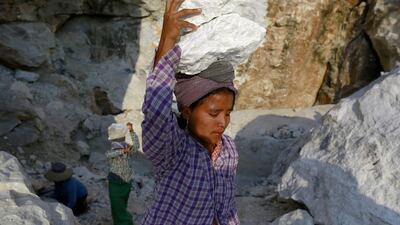 A woman carries marble stones to make Buddha statue images at a marble mine at Zagyin village. Soe Zeya Tun / Reuters