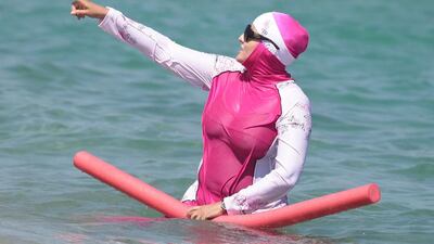 A woman wearing a burqini takes a dip in south of France (Photo by Sipa USA)