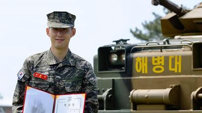 Son Heung-min poses with a prize during a basic military training completion ceremony at a Marine Corps boot camp in Seogwipo on Jeju Island.