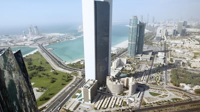 Adnoc would need to find a replacement for the project as energy companies struggle to respond to the collapse of the price of oil. Above, the company headquarters in Abu Dhabi. Christopher Pike / The National