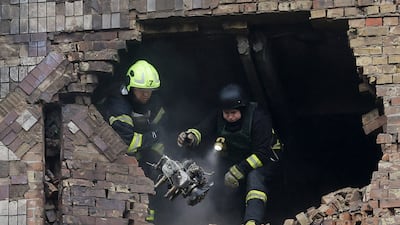 Ukrainian rescuers working at the site where a drone hit a high-rise residential building in Kyiv last month. EPA