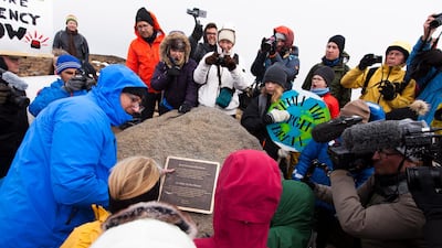Anthropologists from Rice University in Texas Dominic Boyer (left) and Cymene Howe (C-TOP with purple jacket) during the installation of the plaque commemorating the loss of Iceland's Okjokull glacier to climate change, during a public ceremony in Borgarfjordur, Iceland. EPA