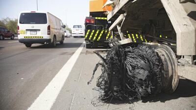 All that was left of a tyre on a military truck transporting refrigerated goods after it blew on the E11 between Dubai and Abu Dhabi. Lee Hoagland / The National