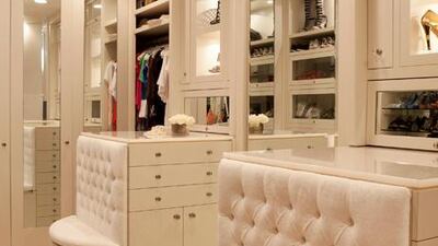 The owner’s wardrobe, just off the en suite master bath, is perhaps the ultimate luxury, with tufted leather benches, custom shelving, a crystal chandelier and marble flooring.