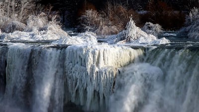 Water flows over the American Falls as viewed from the Canadian side in Niagara Falls, Ont. Aaron Lynett / The Canadian Press via AP