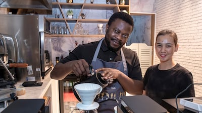 Mae Joaquino and Rene Chi, baristas at Together Cafe, a hole-in-the-wall café which has recently opened in Meyan Mall. It supports deaf people and employs some of them as staff. Victor Besa/The National