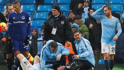 Manchester City's Aymeric Laporte receives medical treatment after sustaining an injury. Reuters