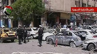 An image grab taken from the state-run Syrian TV shows Syrian police at the scene of a powerful explosion in Marjeh, central Damascus.
