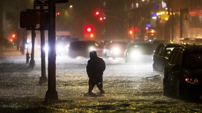 A man navigates a street flooded by heavy rain as remnants of Hurricane Ida hit the area in the Queens borough of New York, New York. EPA