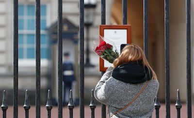 A woman reads the official death notice of Britain's Prince Philip. AP