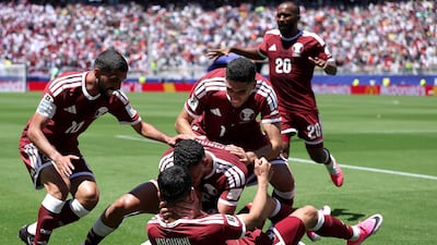 Qatar's Boualem Khoukhi celebrates with teammates after the equaliser against Switzerland at the San Francisco Bay Area Stadium. AFP