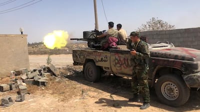Members of GNA forces fire during a fight with Eastern forces, in southern Tripoli in June. Reuters