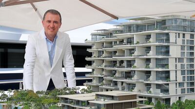 Mahdi Amjad, founder and executive chairman of Omniyat, with a model of the Orla development by Omniyat in Dubai. Pawan Singh / The National