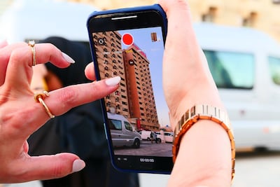 Participants take photos of the Toyota building during a Gulf Photo Plus workshop. Pawan Singh / The National