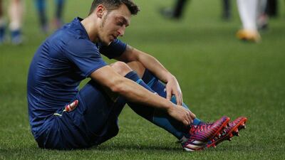 Mesut Ozil of Arsenal reacts after his side's exit from the Champions League on Tuesday against AS Monaco. Yoan Valat / EPA