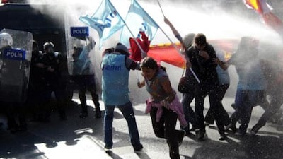 Turkish riot police disperse protesters with a water jets during an anti-International Monetary Fund (IMF) and World Bank protest near the summit area in Istanbul.